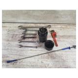 Assortment of adjustable wrenches and drill bits