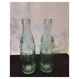 Pair of small coca cola bottles