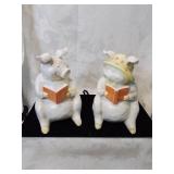 Group of two ceramic pigs reading books