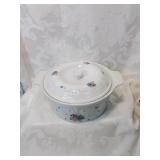 White lidded casserole dish with applied f