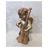 Gold ceramic angel playing musical instrument