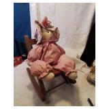 rag doll on a wooden rocking chair