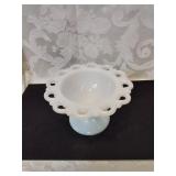 A small milk glass compote four inches tall