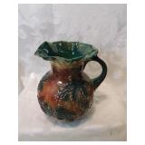 Brown and green pottery pitcher , eight inches