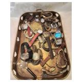 Brass tray of mostly wristwatches