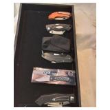 Black velvet tray of four pocket knives includes