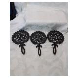 Group of three cast iron trivets