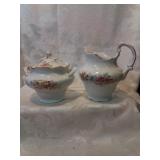 Antique Creamer and sugar with flowers.