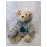 Plush teddy bear with a christmas tree sweater