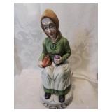 Ceramic female figurine sitting twelve inches tall