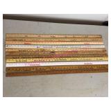 11 Wooden Advertising Yardsticks in Garage