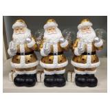 Three Lighted Gold Santas with Snow Globes