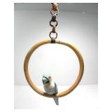 HAND CARVED WOODEN PARROT PERCHED ON A ROUND SWING