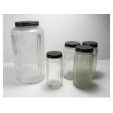 5 RIBBED CLEAR GLASS CONTAINERS WITH BLACK LIDS