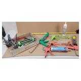 Caulk guns and a tube of caulk