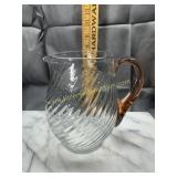 Swirl pattern pitcher with applied pink handle