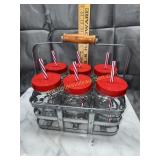 Glass jars with lids and straws in caddy