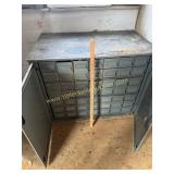 Metal 49 drawer bin with cabinet doors  located
