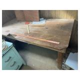 Primitive pine work table  located in basement