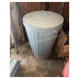 Metal trash can with lid in shop