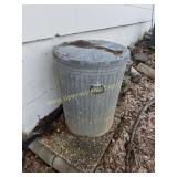 Metal trash can with lid outside