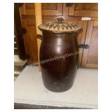 Brown stoneware churn with woven lid