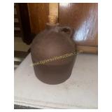 Primitive brown stoneware jug does have crack