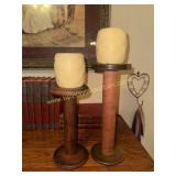 2 wooden textile spools used for candle stands