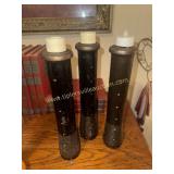 3 black wooden textile spools used for candle
