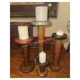 4 wooden textile spools used for candle stands