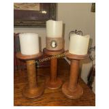 3 wooden textile spools used for candle stands
