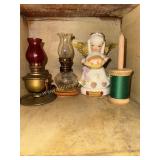 Miniature oil lamps, angel figurines and spool