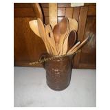 Wooden spoons in brown glazed stoneware pitcher