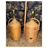 Pair of wicker wrapped green bottles demijohns