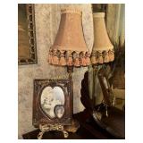 Frame on easel and candlestick style lamp