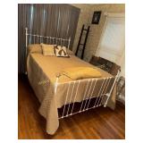 Antique iron bed with bedding and mattress