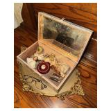 Jewelry box on dresser tray with brooches,