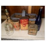 Vintage household bottles and tins in basket