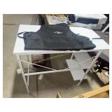 Metal table and Jack Daniels apron