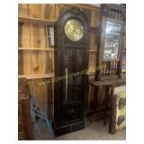Antique carved grandfather clock with brass face