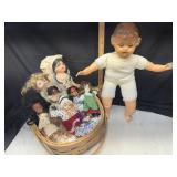 Collection of vintage dolls in basket