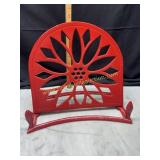 Red enamel over cast book stand