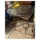 Wicker and iron table with glass top