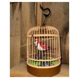 Sound activated toy bird in cage