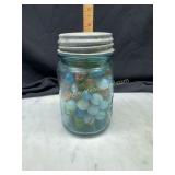 Marbles in blue fruit jar