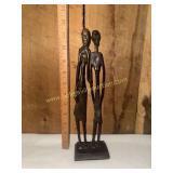 Iron sculpture of tribal man and pregnant woman