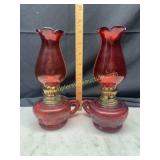 Pair of small red finger hole oil lamps