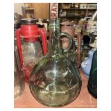 Green glass demijohn wine jug