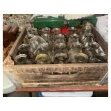 Wooden dairy crate full of glass bottles