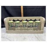 Vintage spice jars with flip top floral lids in